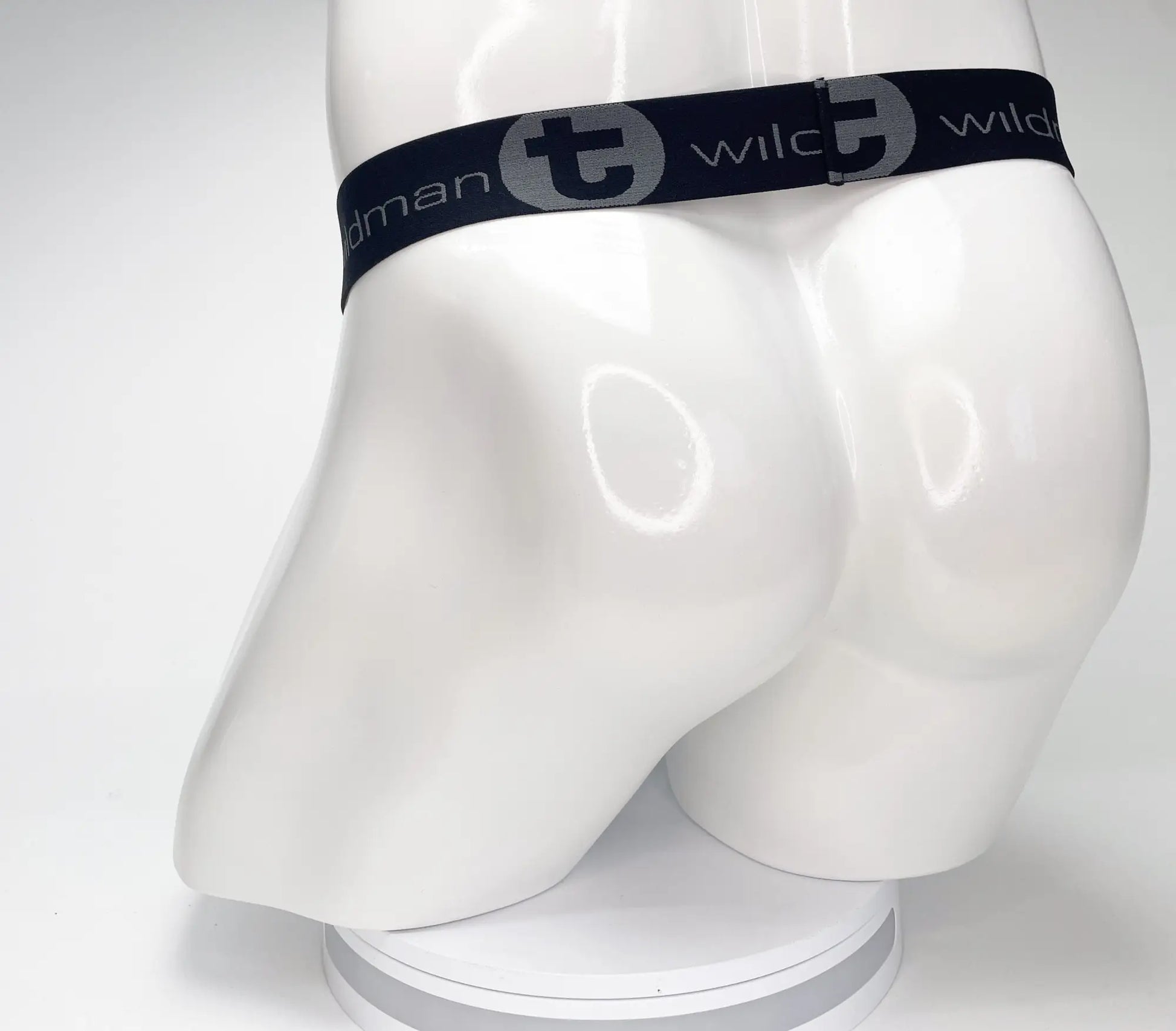 Black elastic waistband with gray wildman branding on mesh monster cock strapless pouch displayed on white mannequin