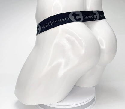 Black elastic waistband with wildman branding and stylized t logo on white mannequin of wildmant mesh monster cock strapless pouch black