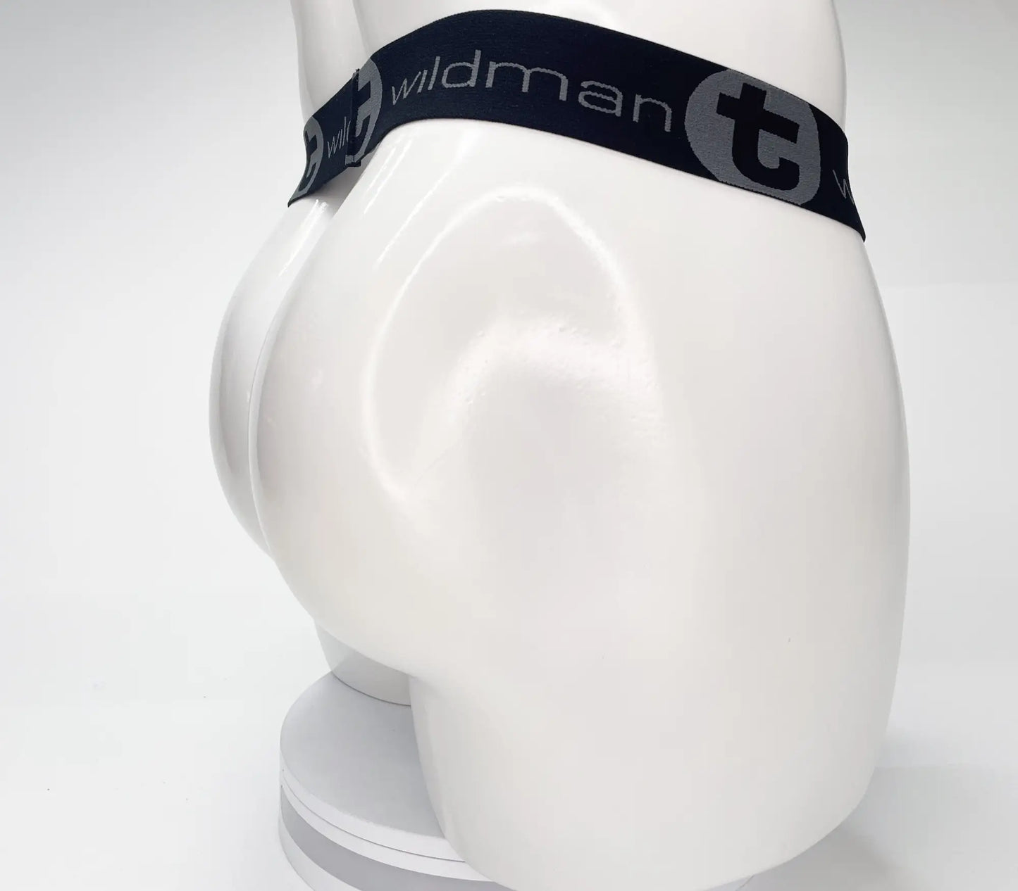 Black elastic waistband wildman mesh monster cock strapless pouch with gray branding on white mannequin front view