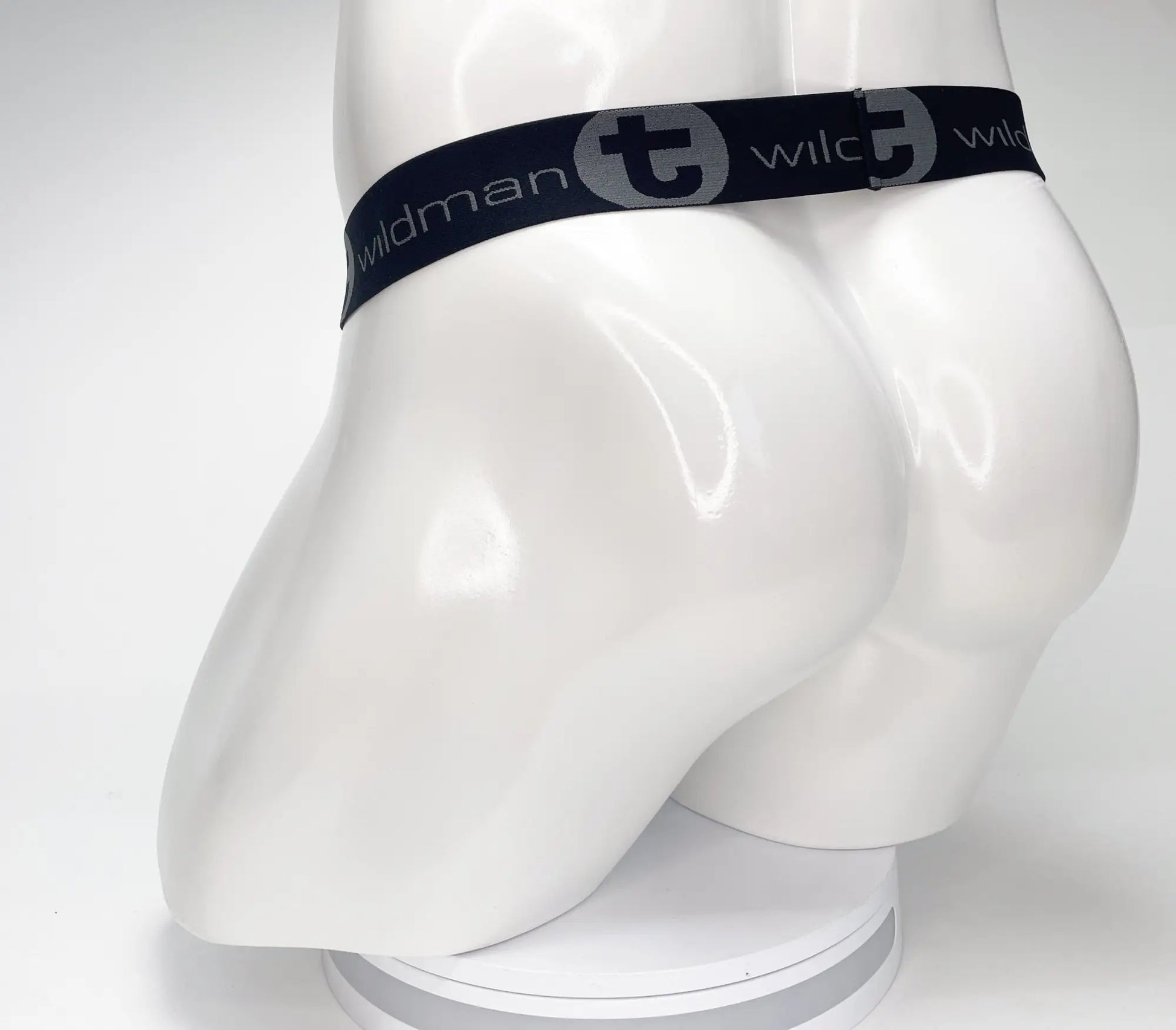 Black elastic waistband with wildman branding on a white mannequin for wildmant mesh monster cock strapless pouch black