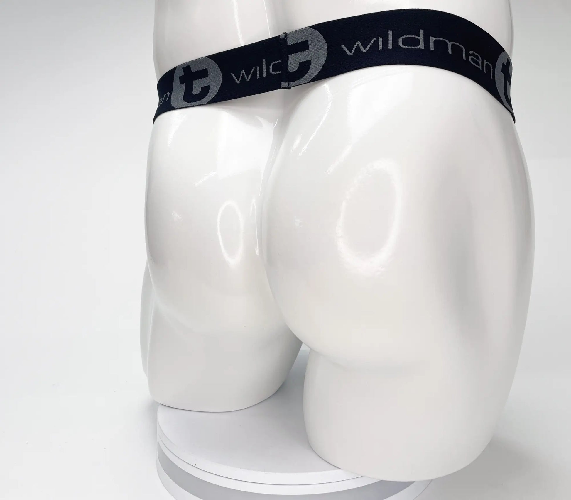 Black elastic waistband with wildman branding on mesh monster cock strapless pouch black displayed on mannequin