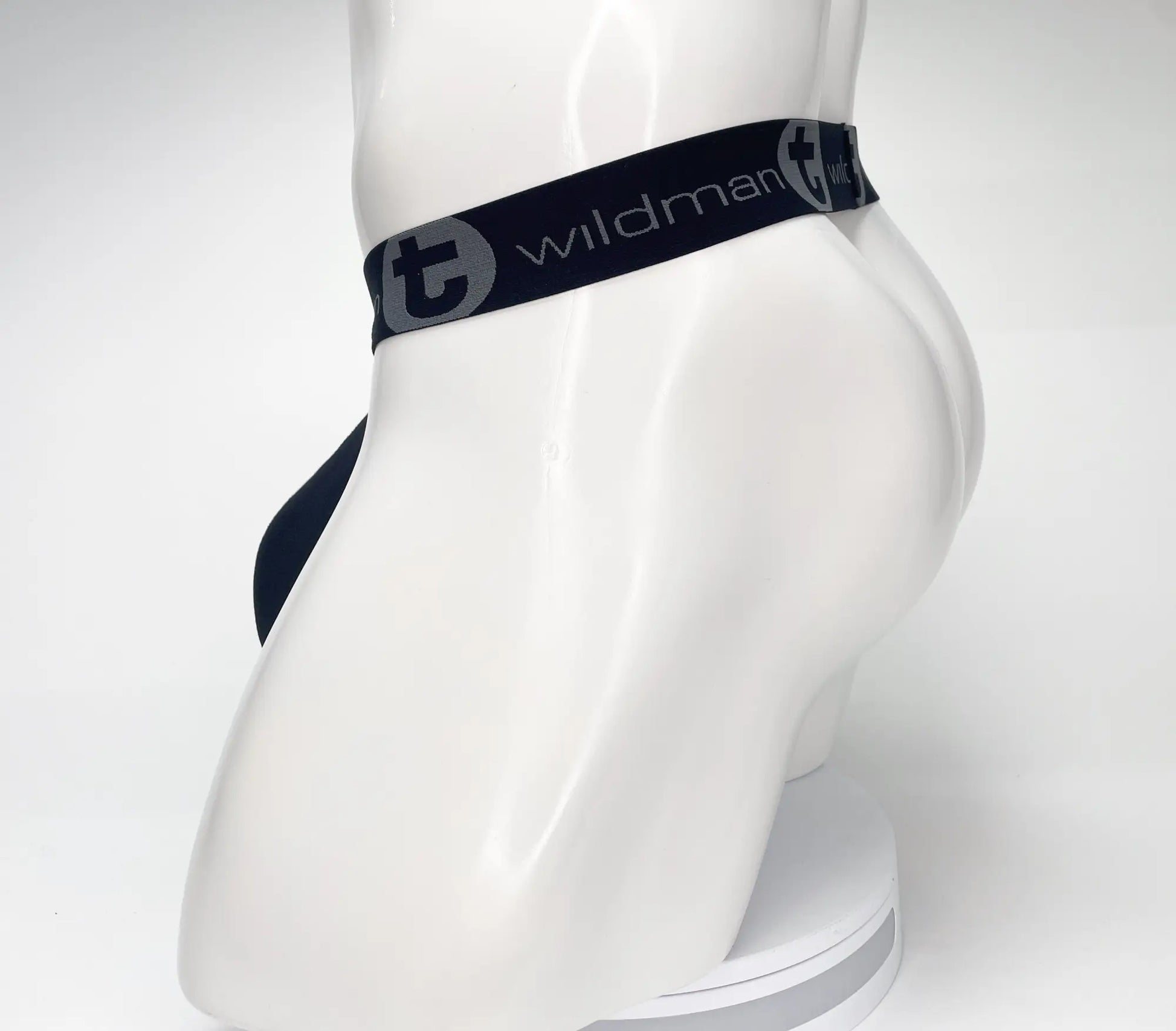 Navy blue wildman briefs with black elastic waistband featuring white wildman logo mesh monster cock strapless pouch black