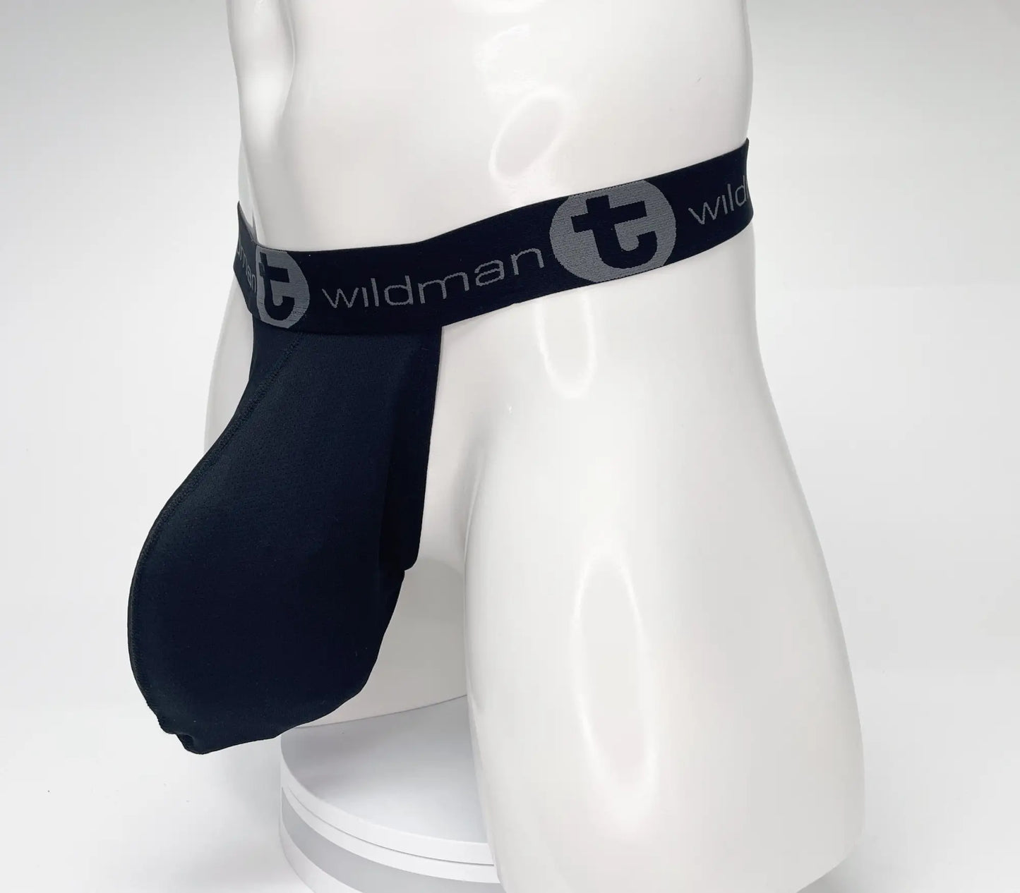 Navy blue wildman brand jockstrap with elastic waistband and logo detailing from wildmant mesh monster cock strapless pouch black collection