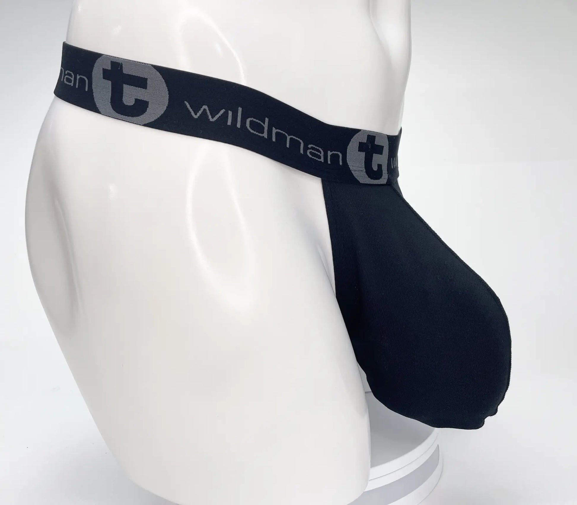 Black wildman brand men’s briefs with a gray logo band featuring a mesh monster cock strapless pouch in black