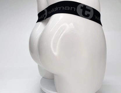 Black elastic waistband with wildman branding and circular logo on white mannequin for wildmant mesh monster cock strapless pouch white