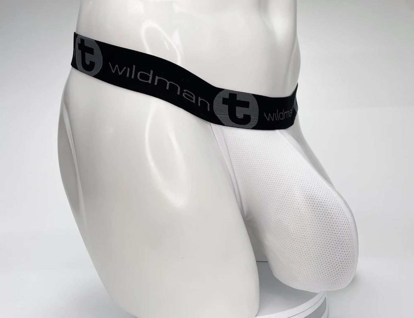White mesh briefs with black elastic waistband featuring wildman brand logo in gray from wildmant mesh monster cock strapless pouch white