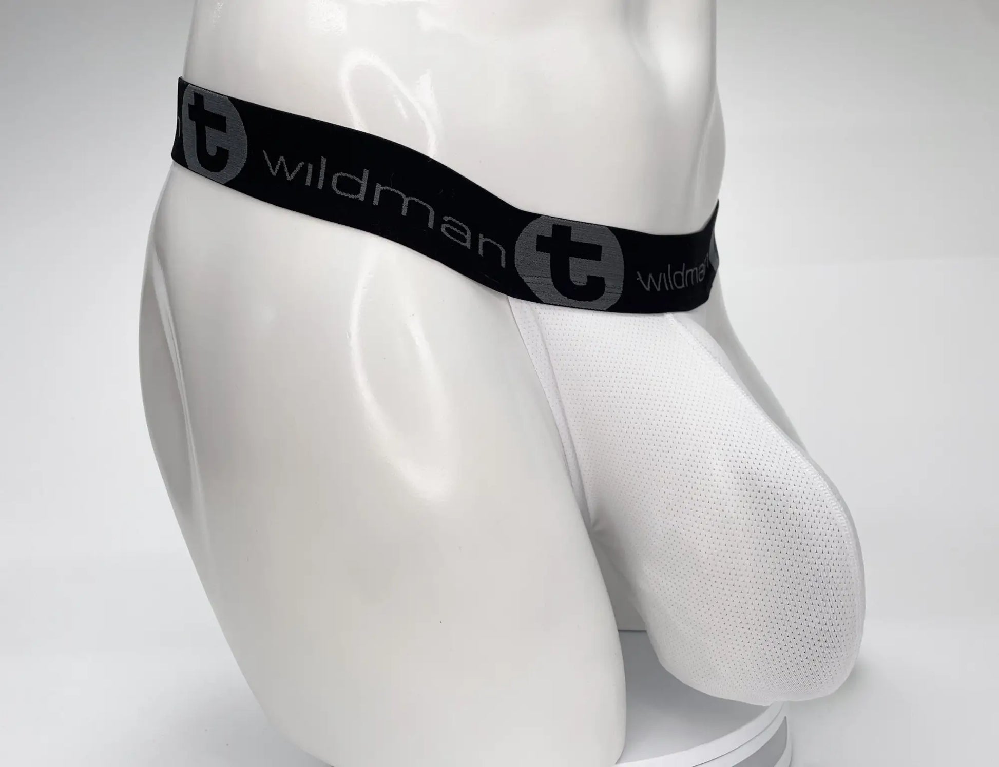 White mesh briefs with black elastic waistband featuring wildman brand logo in gray from wildmant mesh monster cock strapless pouch white