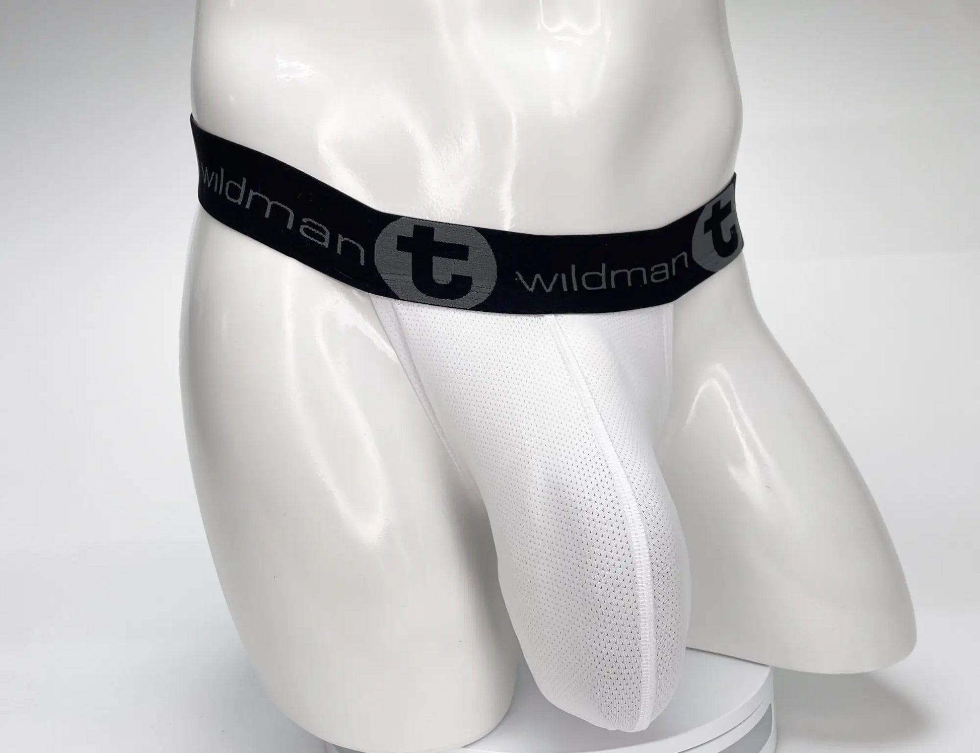 White mesh WildmanT mesh monster cock strapless pouch briefs with black elastic waistband featuring logo