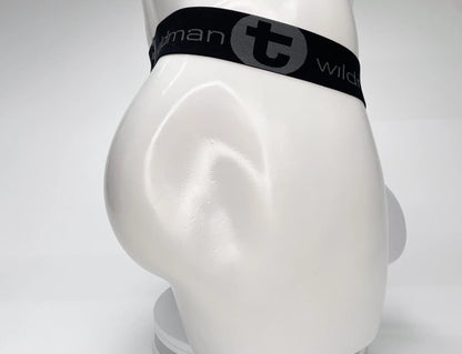 White WildmanT mesh strapless pouch worn on a white mannequin with a black elastic waistband featuring logo branding.