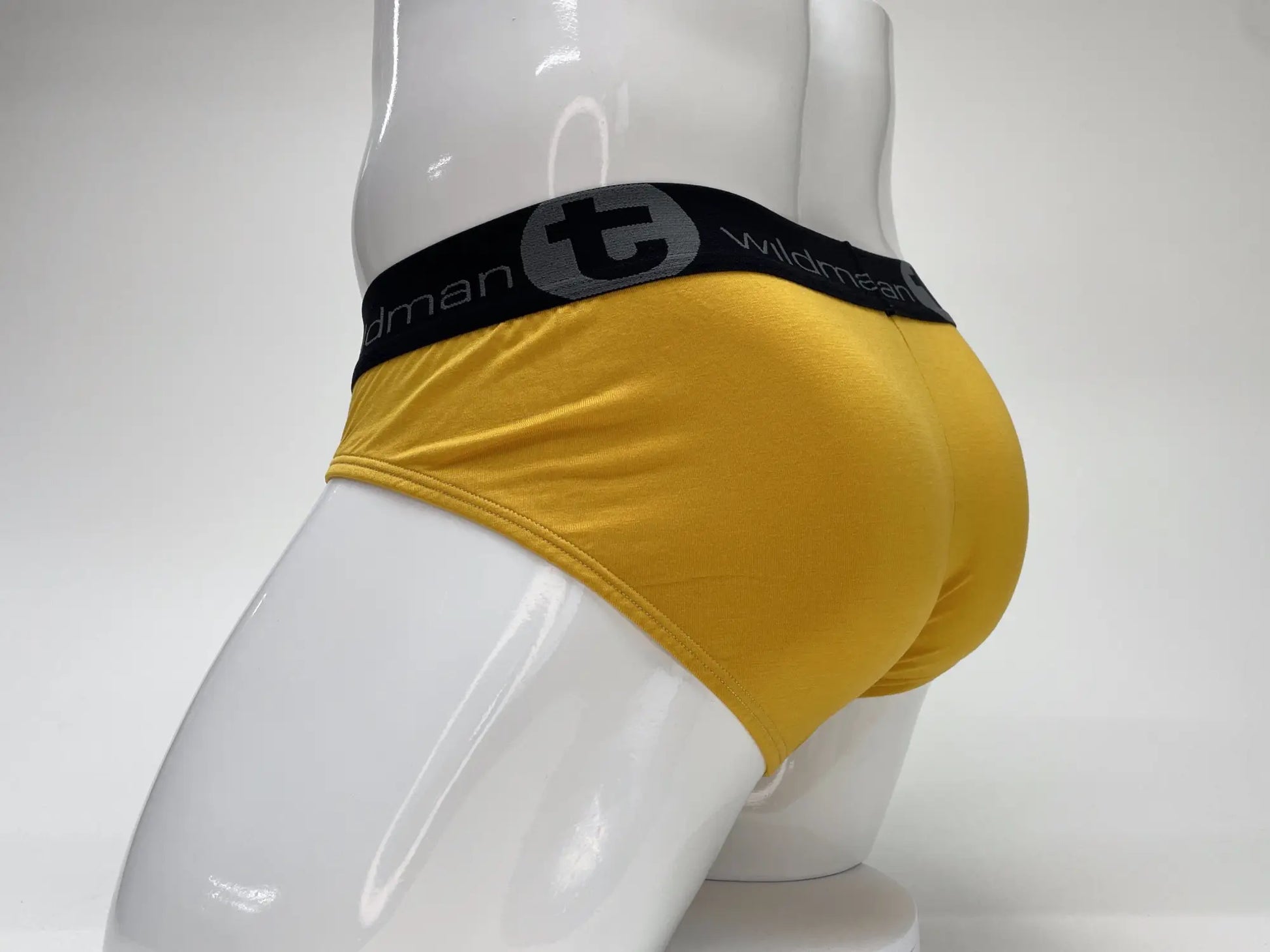 Yellow wildman modal big boy pouch brief with a black waistband featuring the wildman brand logo in gold color