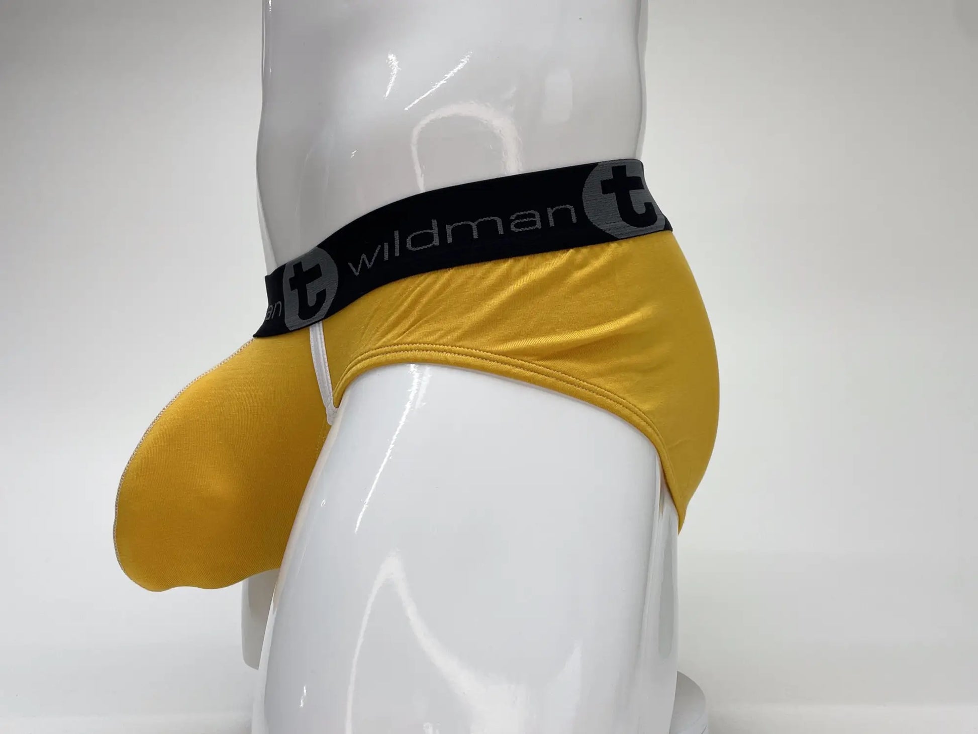 Yellow wildman brand modal big boy pouch brief in gold with black elastic waistband featuring t logo and brand name