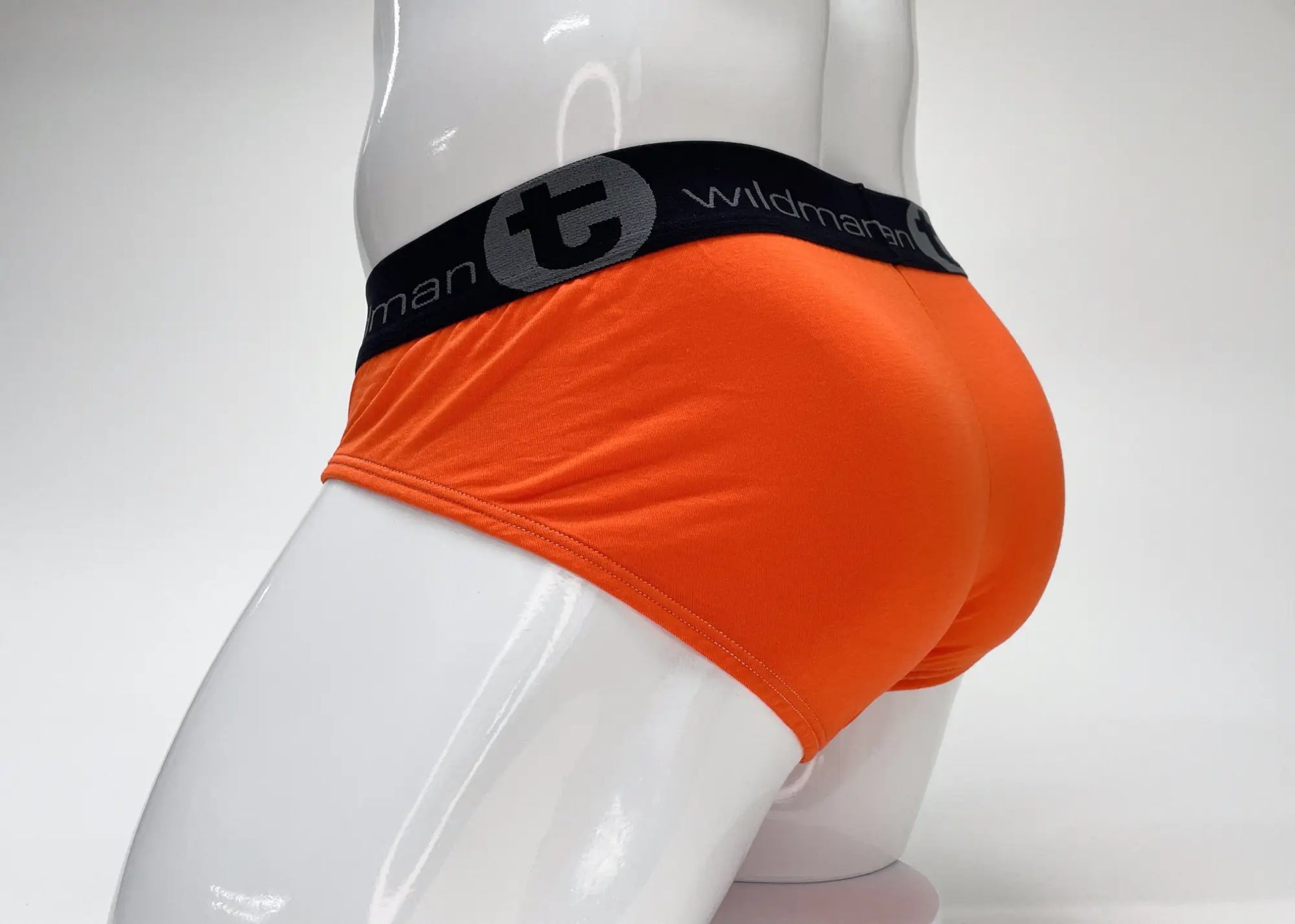 WildmanT modal big boy pouch brief in bright orange with black elastic waistband featuring wildmann logo