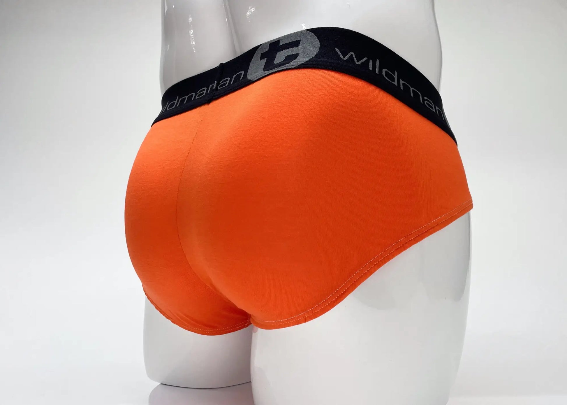 Bright orange wildmanT modal big boy pouch briefs with black elastic waistband featuring wildman brand name and logo
