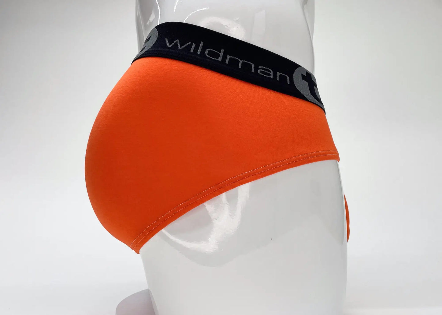 Bright orange wildmant modal big boy pouch brief with black elastic waistband and gray wildman branding