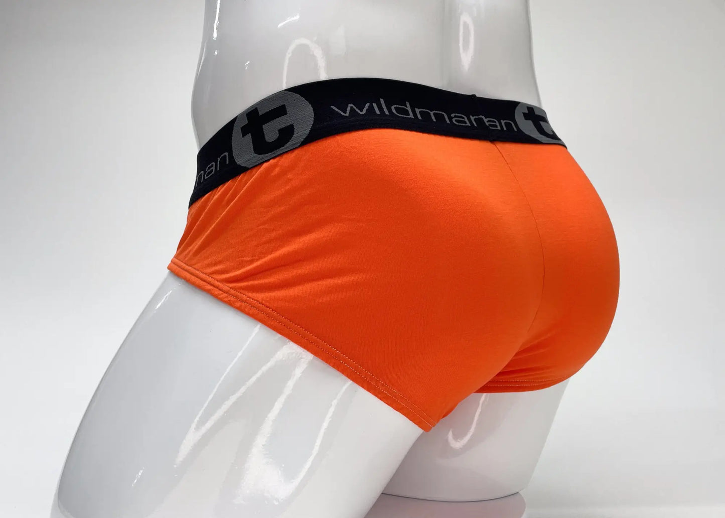 Bright orange wildmanT modal big boy pouch brief with black elastic waistband and wildman logo and brand name