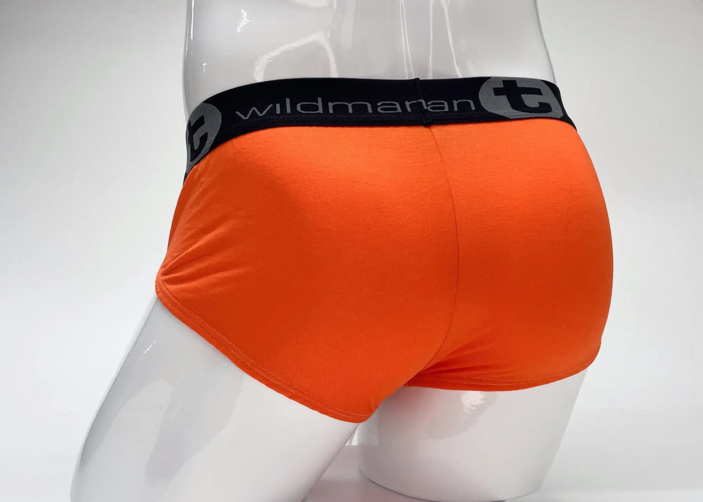 Bright orange wildmanT modal big boy pouch brief with black waistband featuring wildmaran brand name and logo