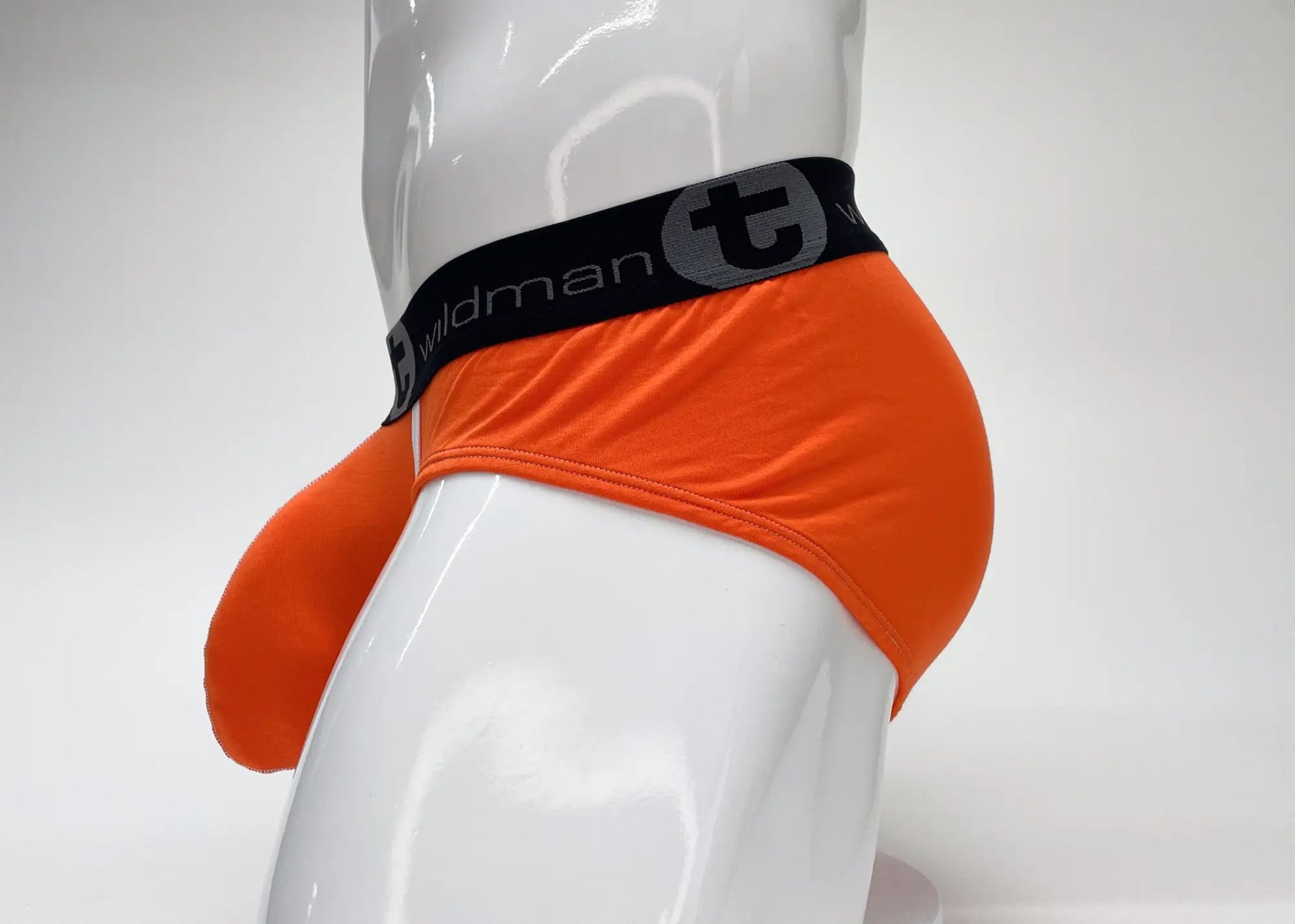 Bright orange wildmant modal men’s briefs with black waistband pouch and stylized t emblem for comfortable support