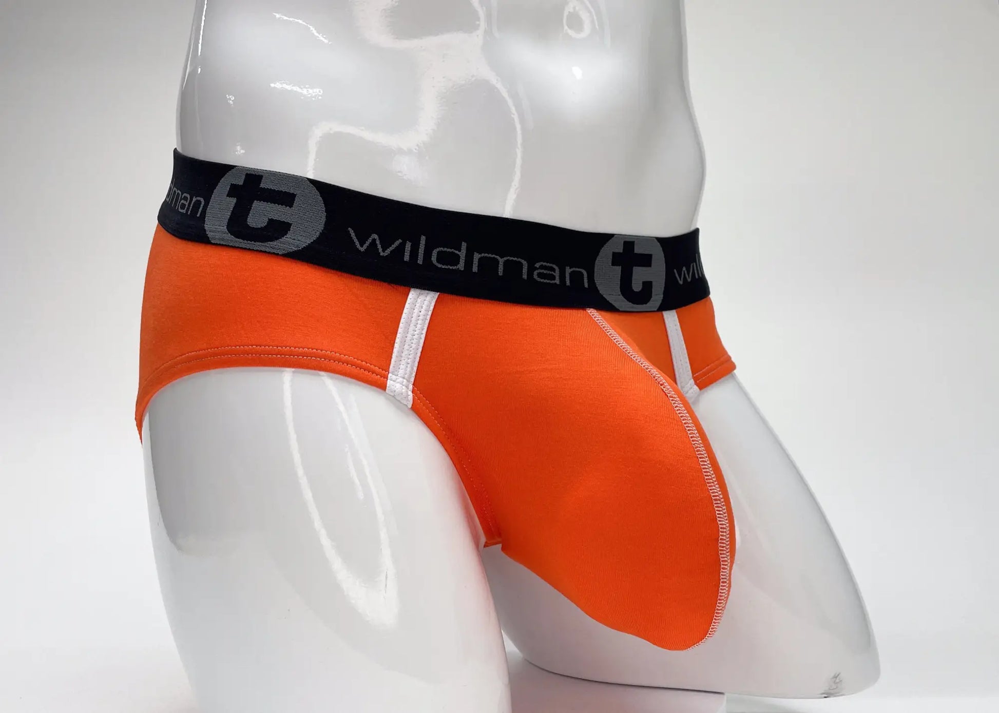 Bright orange wildmanT modal big boy pouch brief with black waistband and gray emblem for men’s underwear