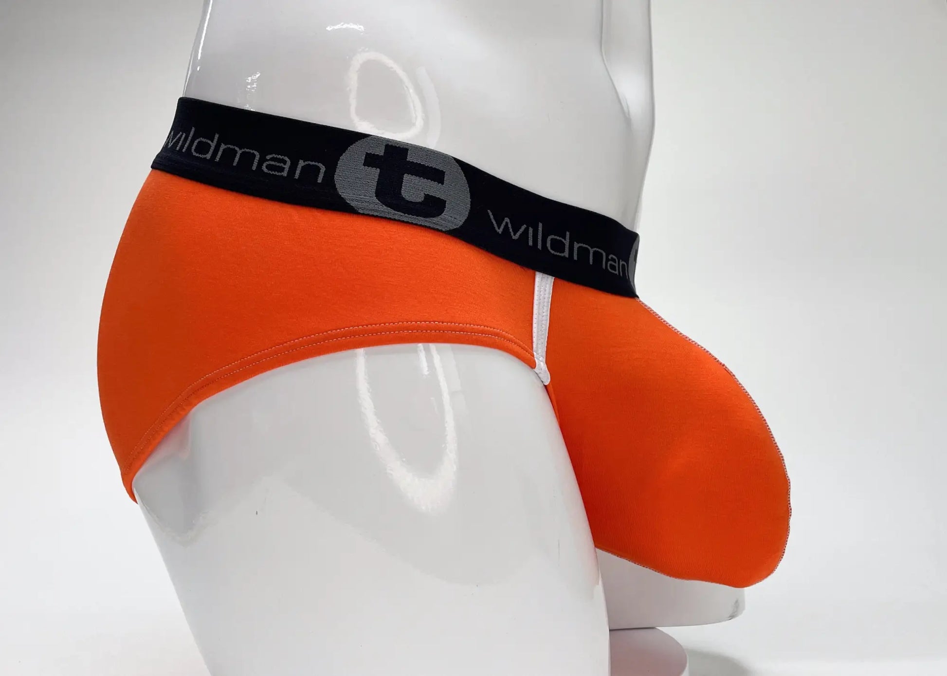 Bright orange wildmant modal big boy pouch brief with black waistband featuring brand name and logo