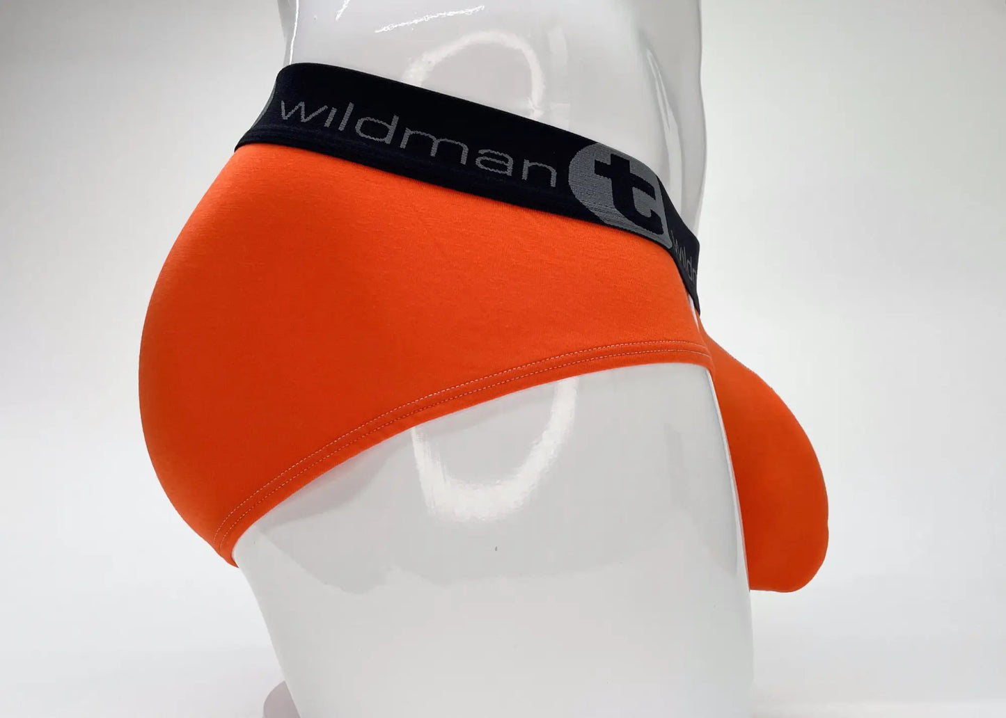 Bright orange wildmant modal big boy pouch brief for men with black waistband and wildman logo and brand name