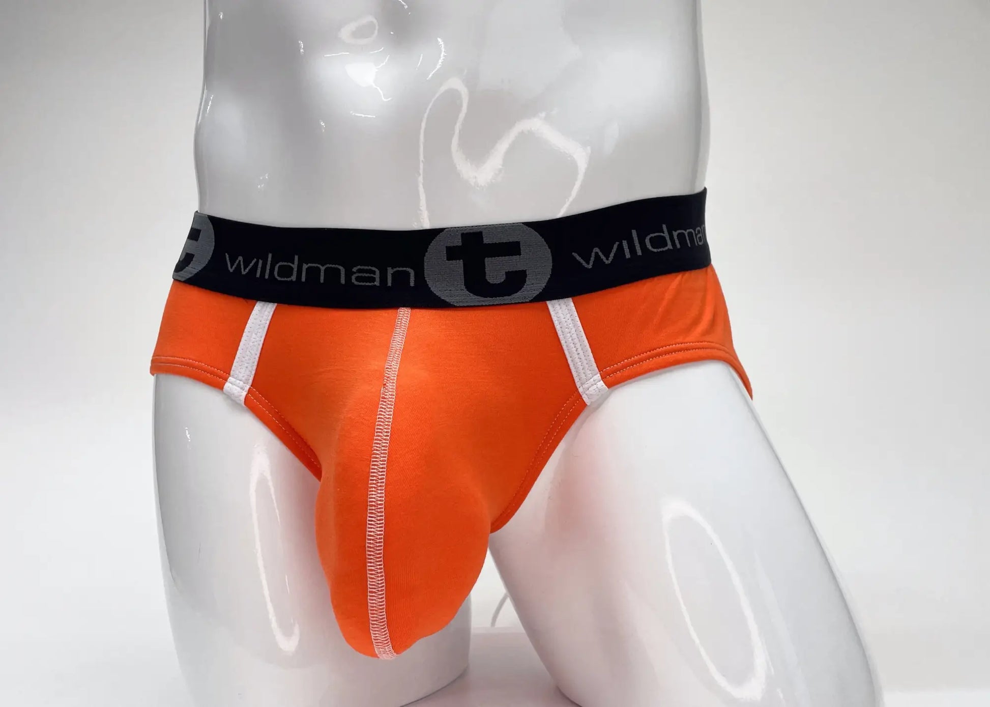 Bright orange wildmant modal big boy pouch brief with black waistband and white wildman logo