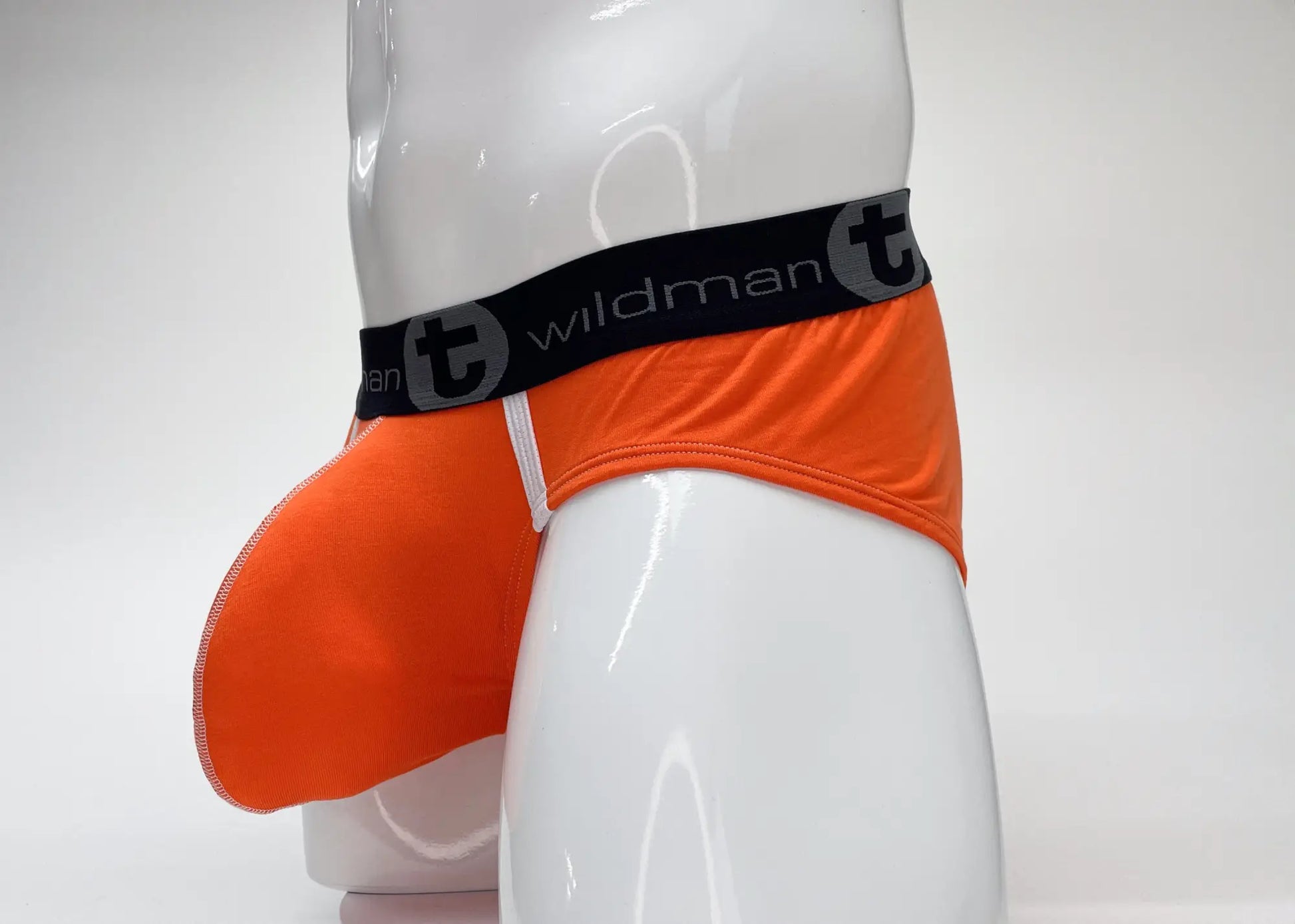 Wildmant modal big boy pouch brief in orange with black waistband featuring t logo and text in front view