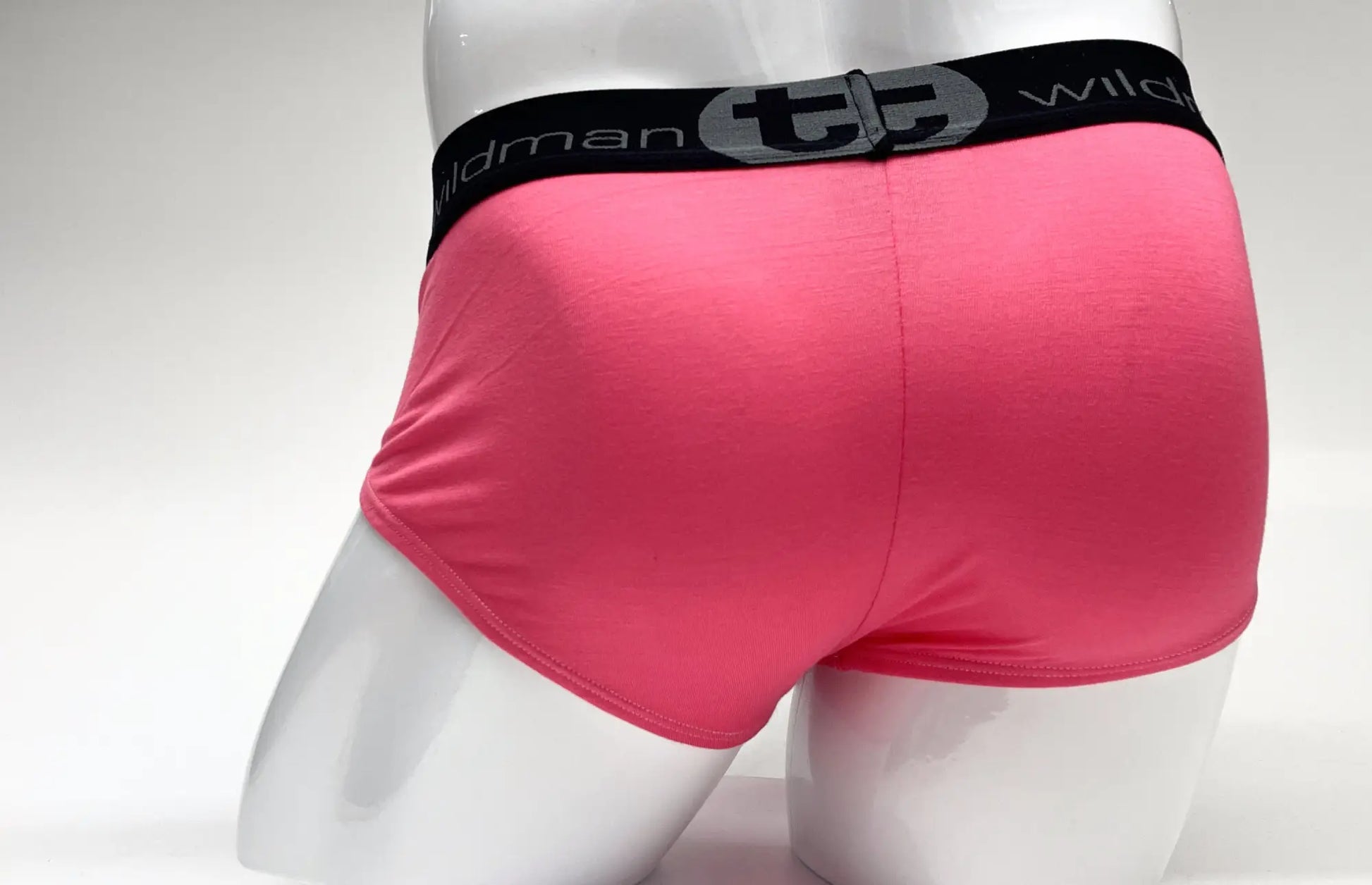 Bright pink wildmanT modal big boy pouch brief with a black elastic waistband featuring the wildman logo and text