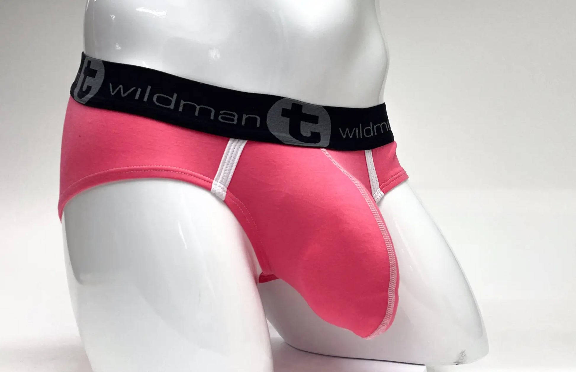 Pink wildmant modal big boy pouch brief with black elastic waistband logo and white stitching along seams