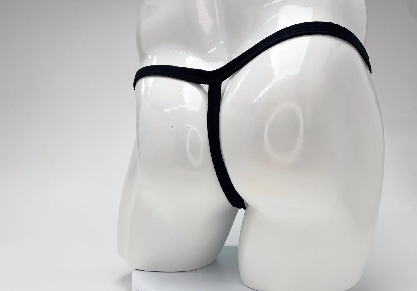 Black thong displayed on white mannequin featuring wildmanT modal micro thong big boy pouch in baby blue color