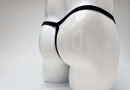 Black thong with a thin waistband on a glossy white male mannequin torso against a white background.