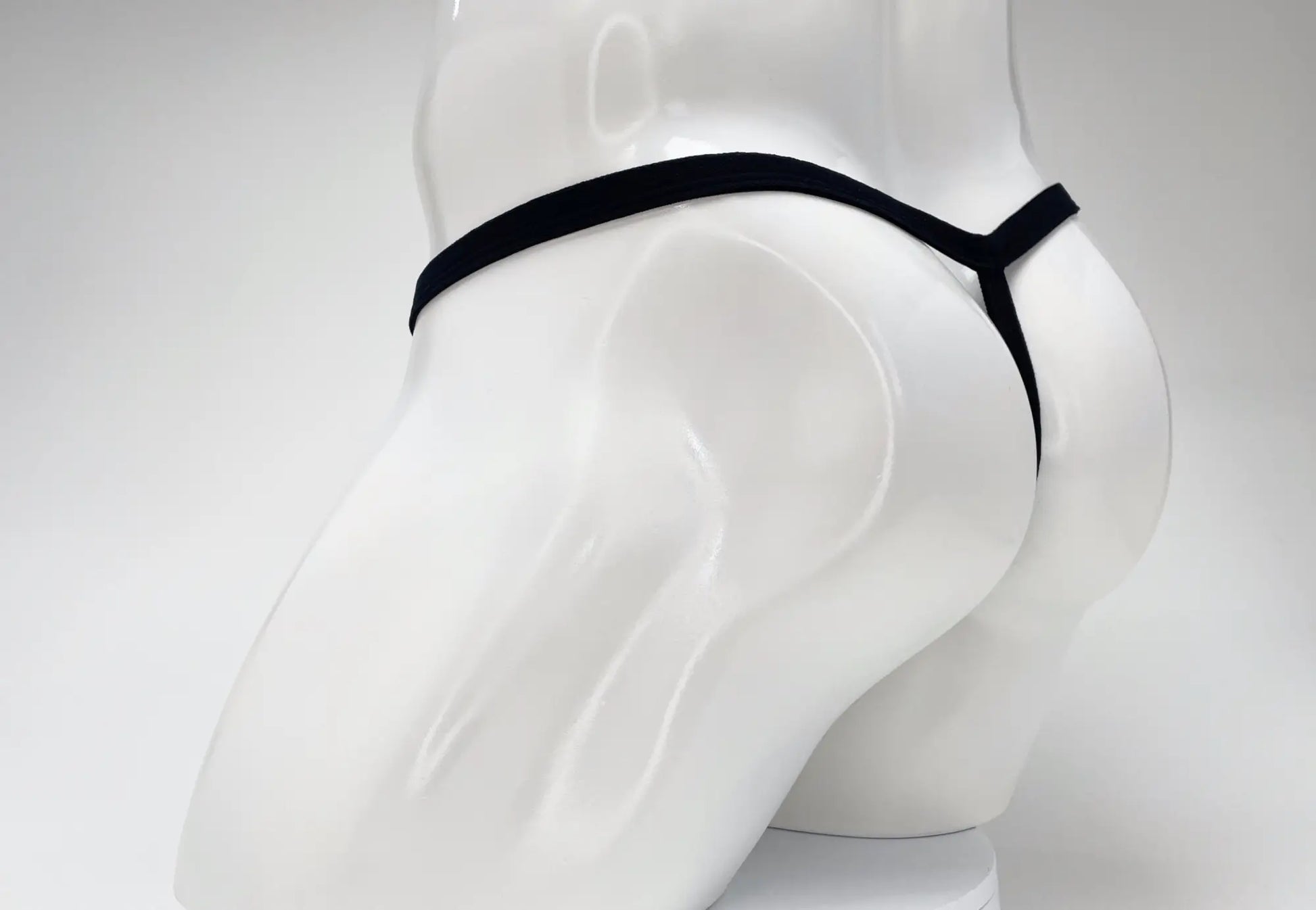 Black elastic thong with minimalist design made from modal fabric featuring big boy pouch by wildmant
