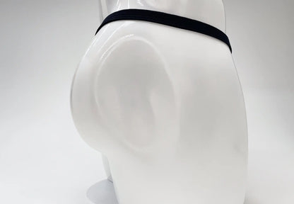 Black elastic waistband of wildmant modal micro thong big boy pouch gold briefs on white mannequin front view