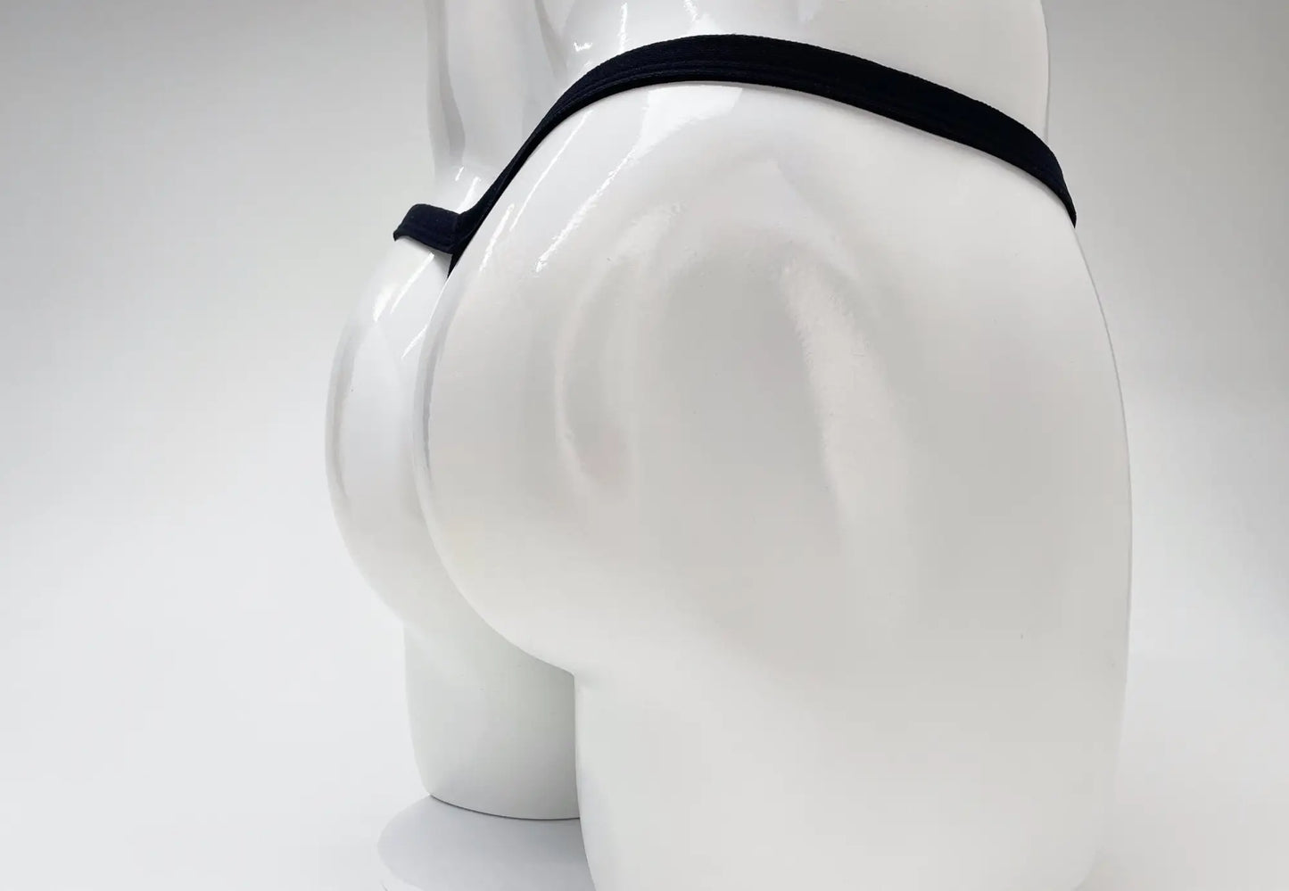 Black elastic waistband wildmant modal micro thong with big boy pouch displayed on white mannequin front view