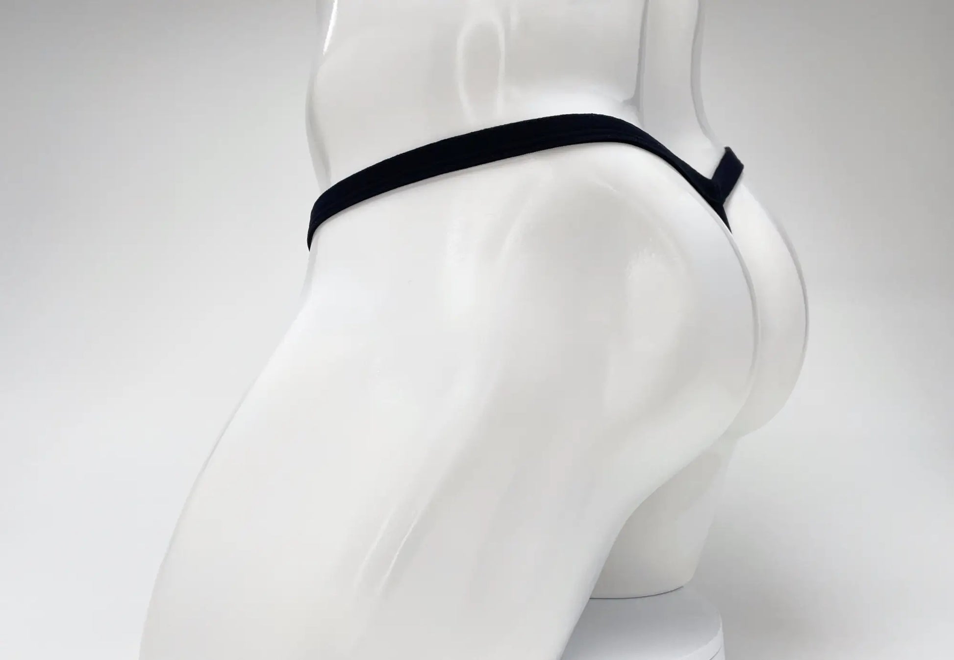 Black elastic waistband wildmant modal micro thong with big boy pouch displayed on white mannequin