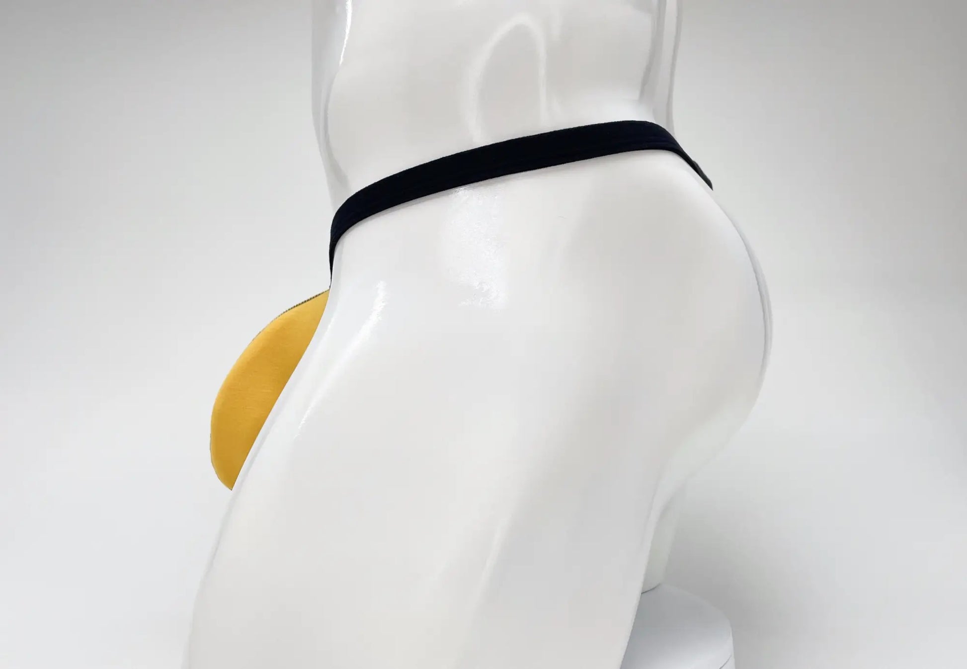 Wildmant modal micro thong big boy pouch gold with black elastic waistband and yellow padded front pouch