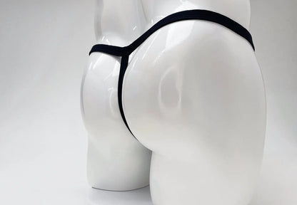 Black thong with big boy pouch in modal fabric displayed on white mannequin for wildmant product titled gold