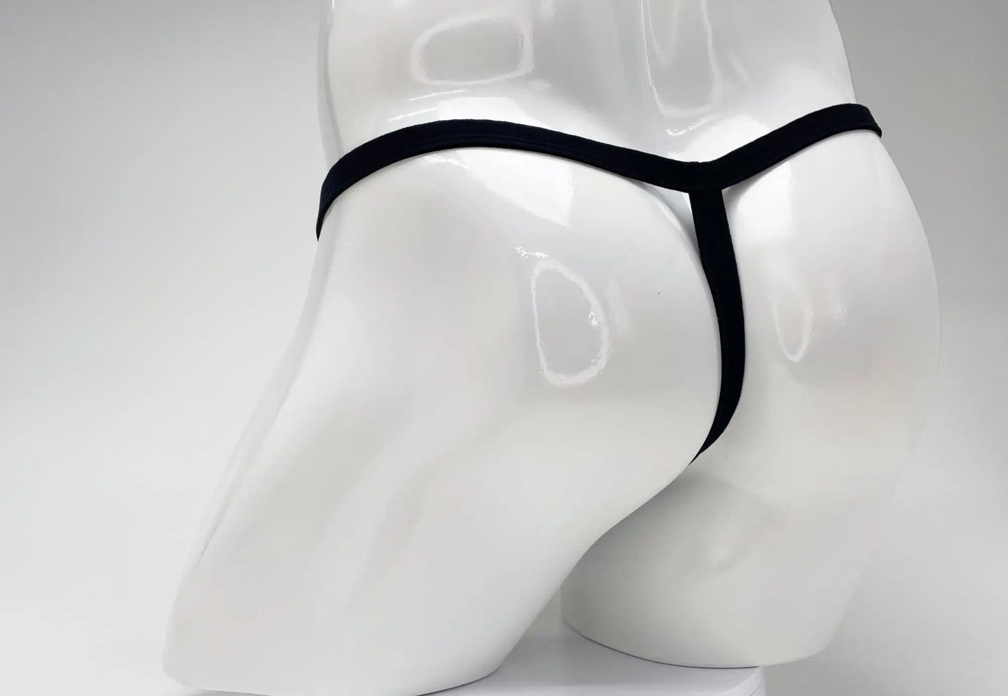 Black thong wildmant modal micro thong big boy pouch gold displayed on white mannequin front view