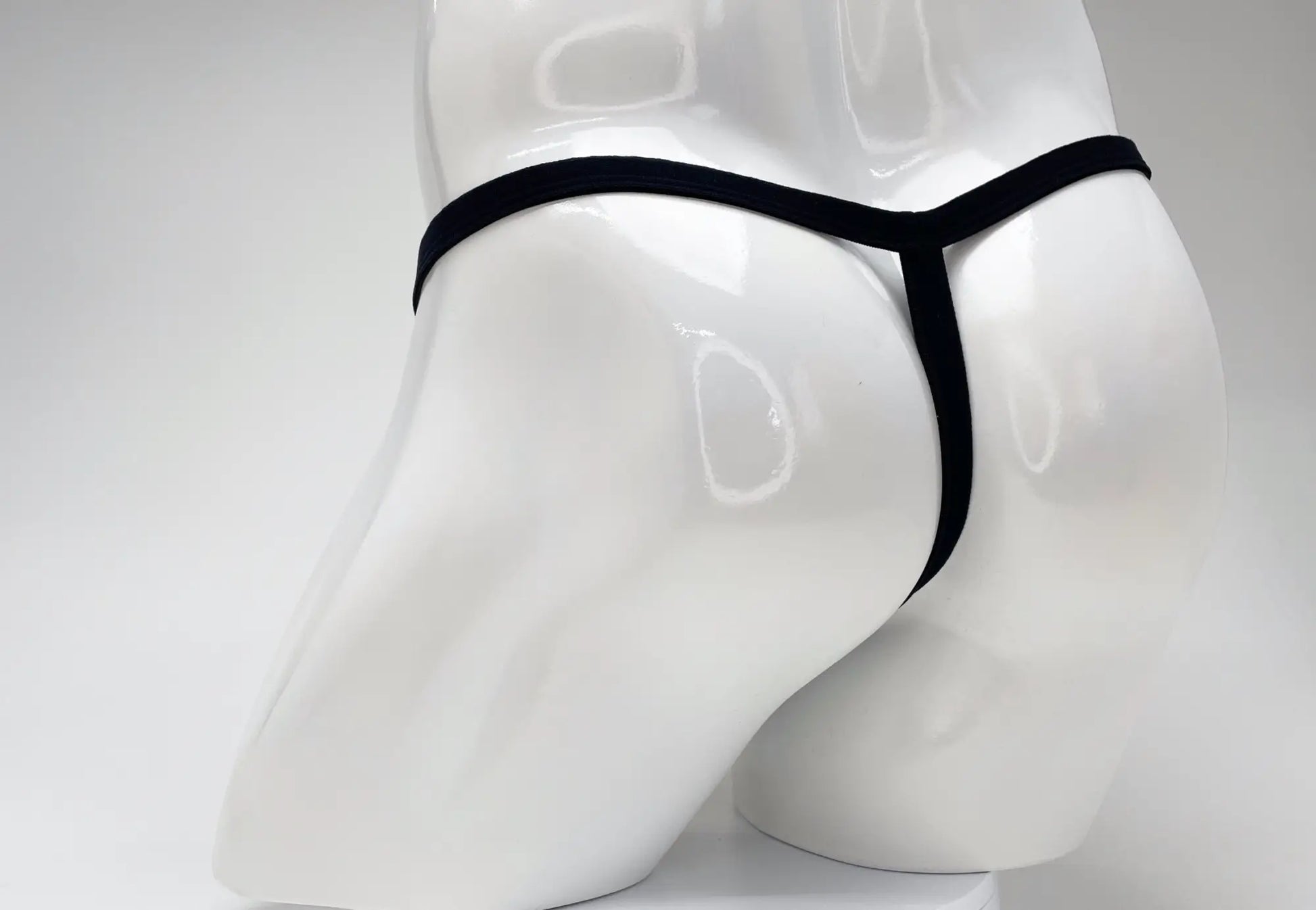 Black thong wildmant modal micro thong big boy pouch gold displayed on white mannequin front view