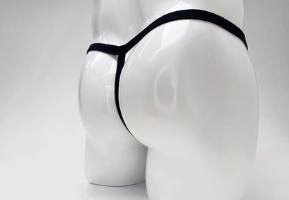 Black WildmanT modal micro thong on a white mannequin, showing a minimalist T-back design.