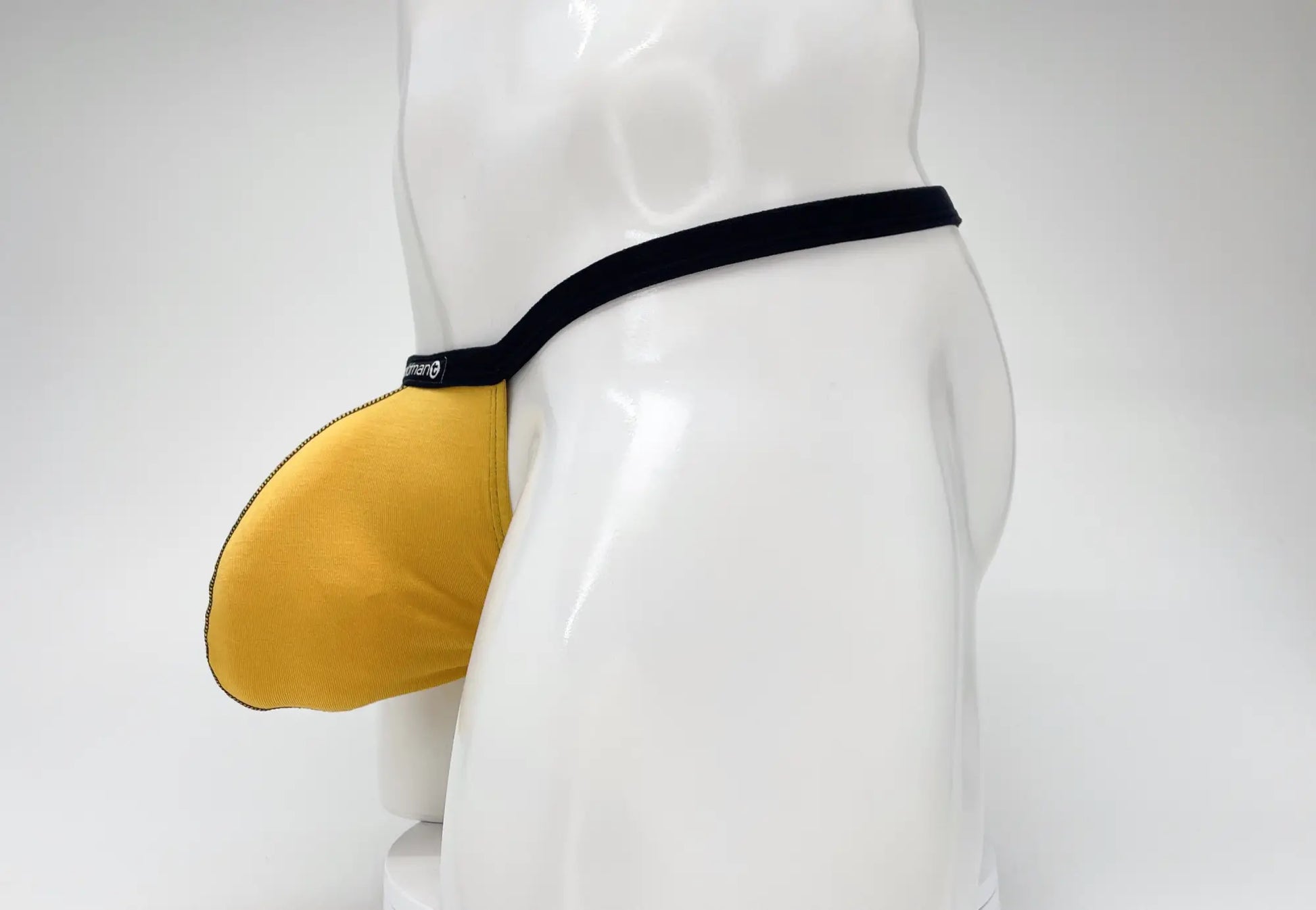 Yellow wildmant modal micro thong jockstrap with black elastic waistband and gold big boy pouch