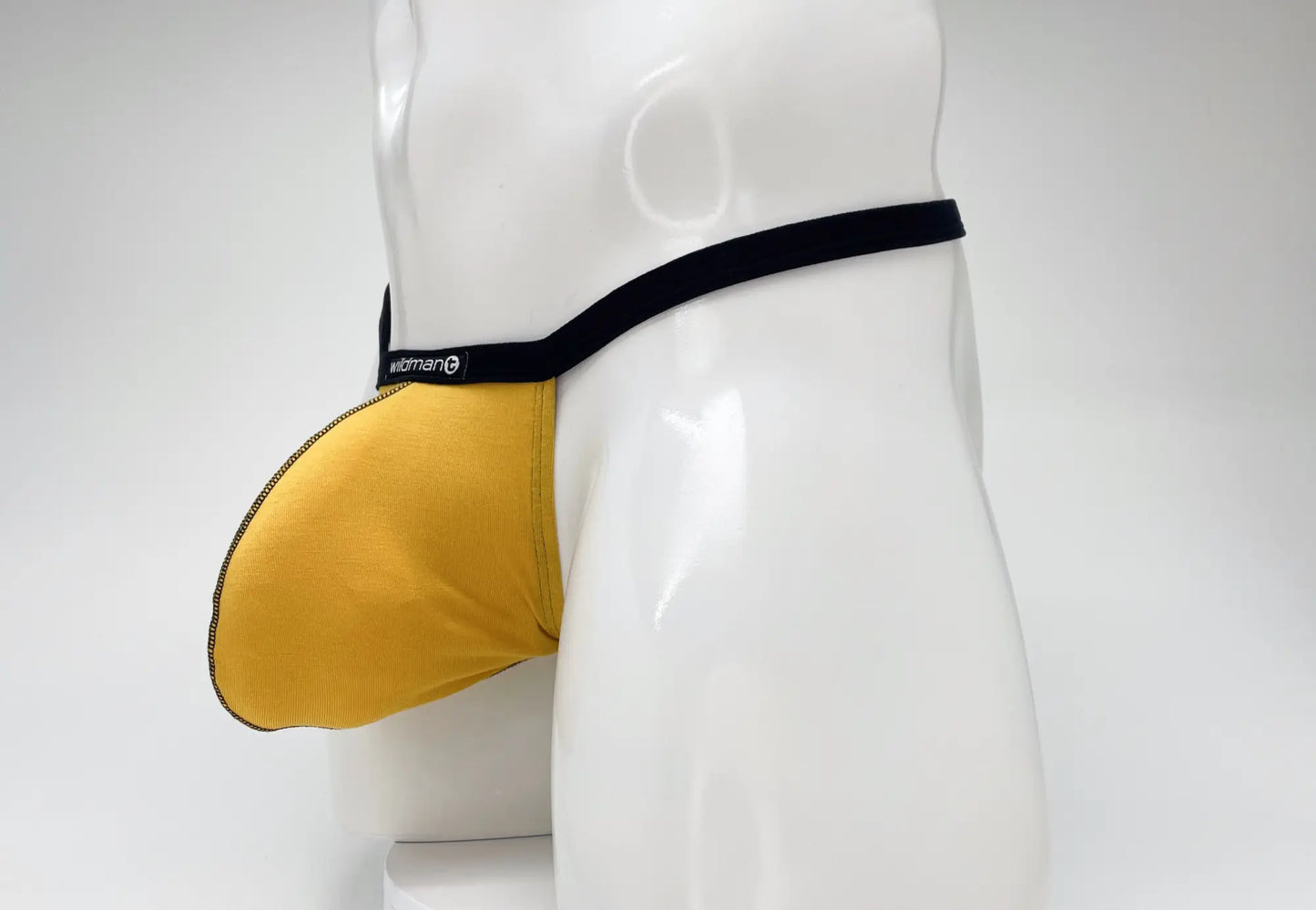 Gold WildmanT modal micro thong with a large pouch and black waistband on a white mannequin torso.