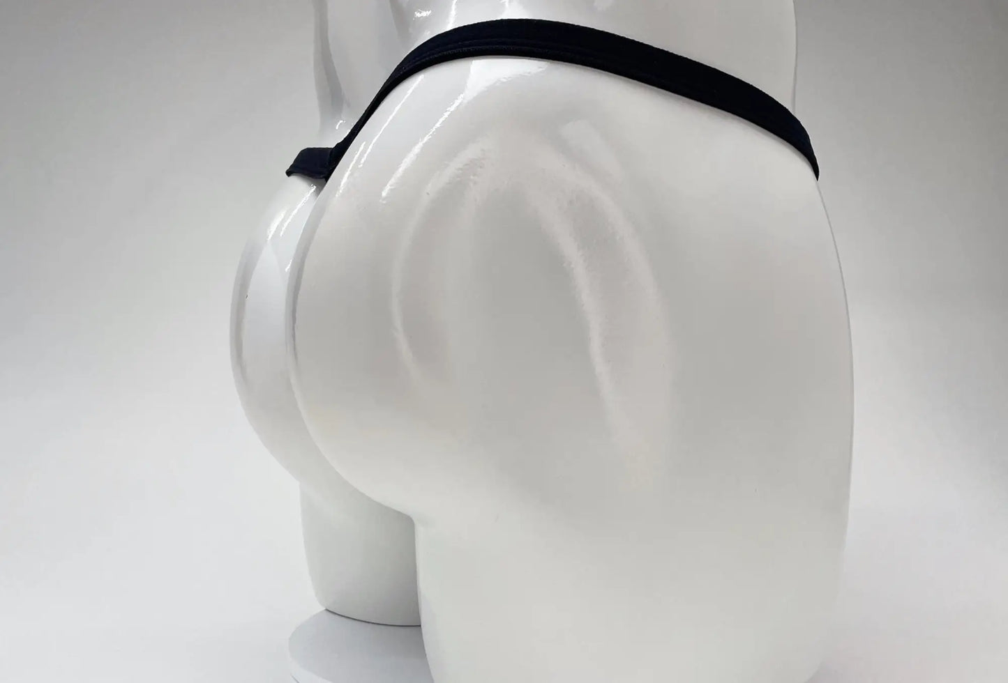 Wildmant modal micro thong big boy pouch in black elastic waistband displayed on white mannequin front side