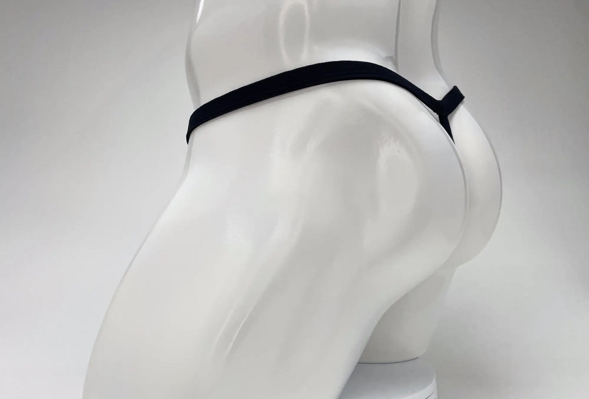 Black elastic waistband wildmant modal micro thong with big boy pouch displayed on white mannequin