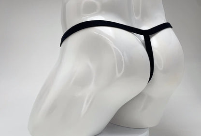 Back view of a white male mannequin wearing a minimalist black thong with a thin waistband and vertical strap.