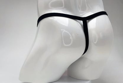 Rear view of a white male mannequin wearing a minimal black thong with a thin waistband and vertical strap.