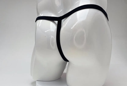 Black thong displayed on white mannequin featuring wildmant modal micro thong big boy pouch in pink
