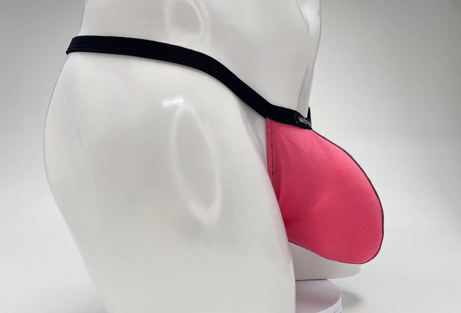 Pink wildmanT modal micro thong jockstrap with black elastic waistband featuring big boy pouch design