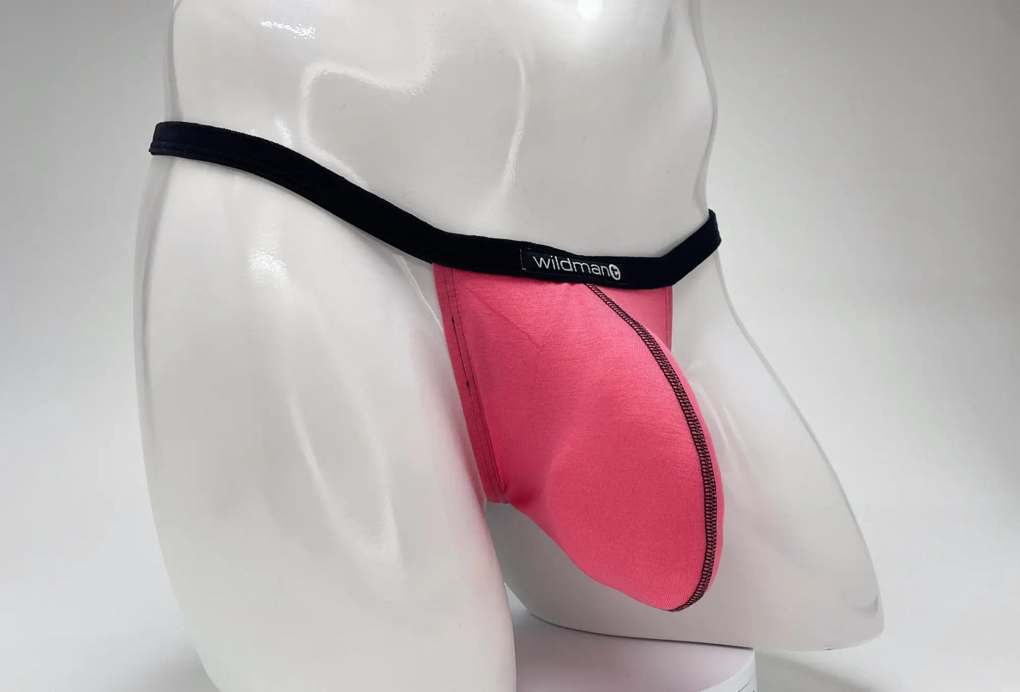 Pink wildman brand modal micro thong briefs with black elastic waistband and stitched seams featuring big boy pouch