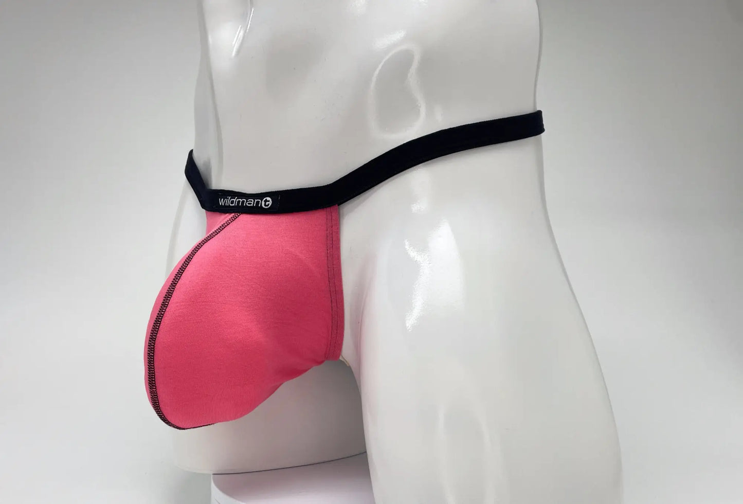 Pink wildman brand men’s supportive modal micro thong briefs with black waistband and big boy pouch design