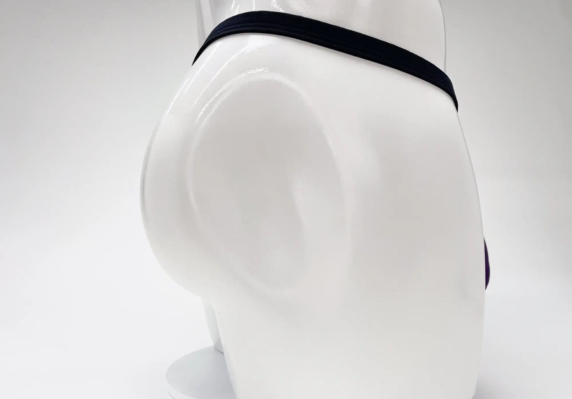 Black elastic waistband of wildmant modal micro thong big boy pouch purple men’s underwear on mannequin front view